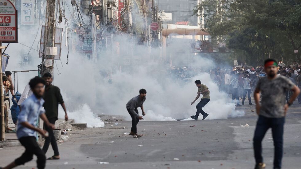 Demonstranten werfen Steine und rufen Parolen während einer Auseinandersetzung mit der Polizei in Bangladesch. Demonstranten werfen Steine und rufen Parolen während einer Auseinandersetzung mit der Polizei in Bangladesch.
